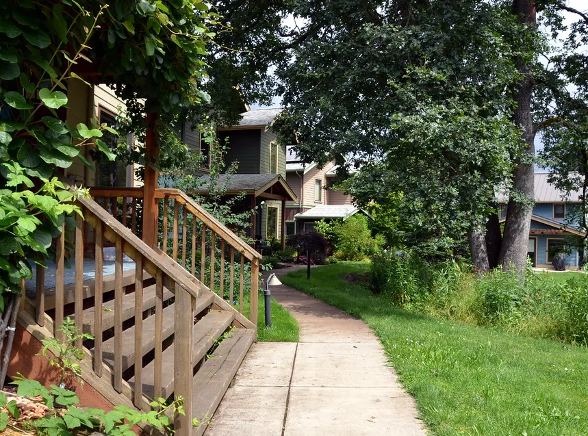 Wooden steps climbing beside a house to a raised entrance